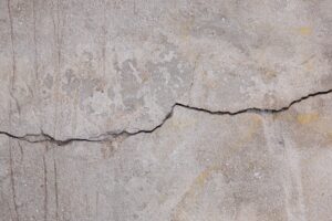 A crack running across a concrete slab before epoxy flooring over cracked concrete is installed