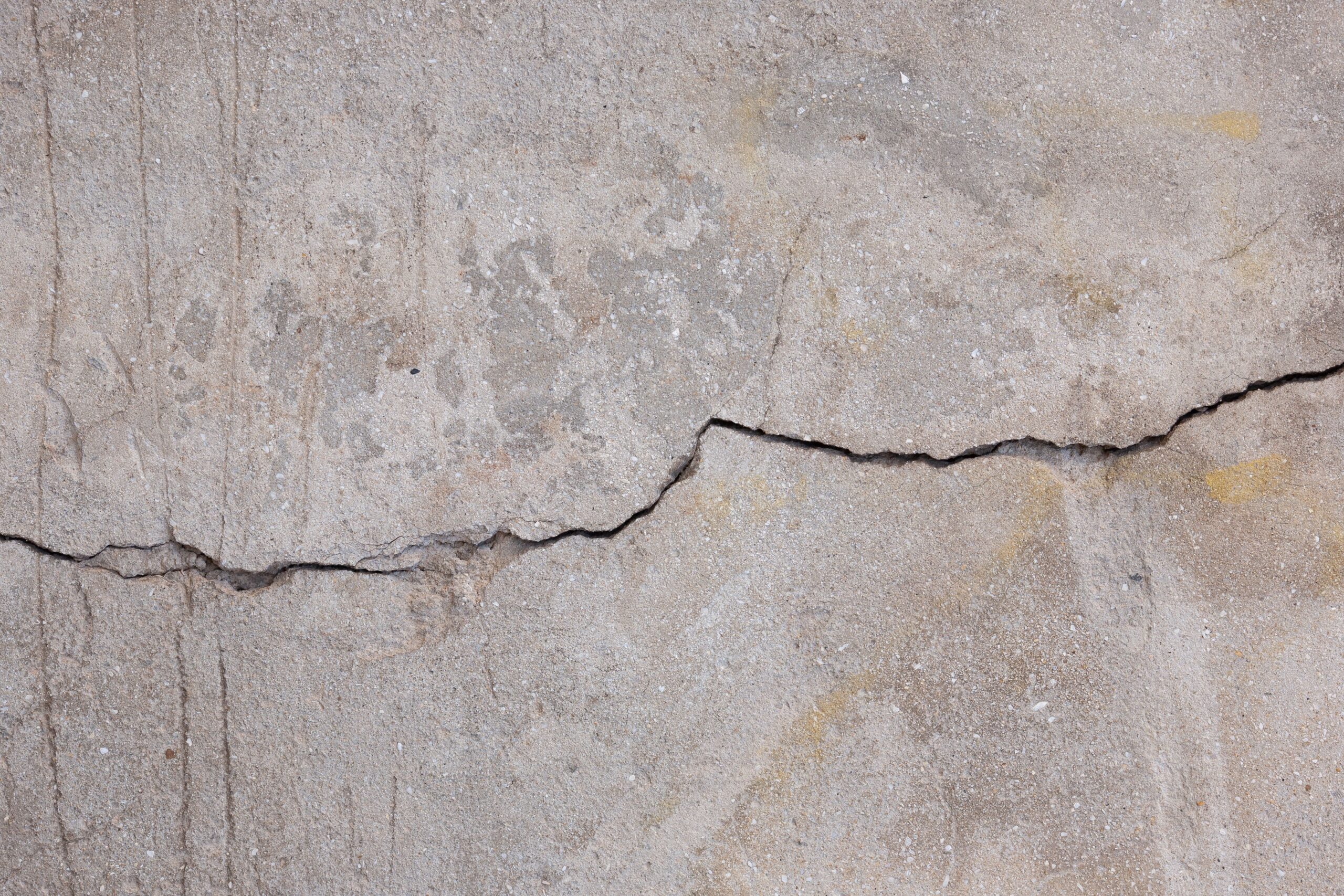 A crack running across a concrete slab before epoxy flooring over cracked concrete is installed